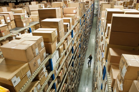 Man taking inventory in warehouse, aerial view