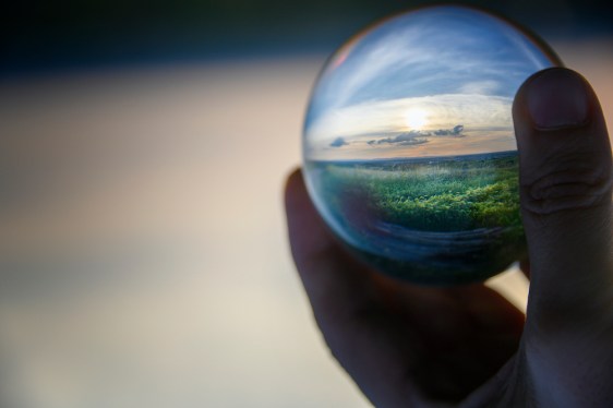 Dreamy landscape in handheld lensball (Original Title: "Preservation")