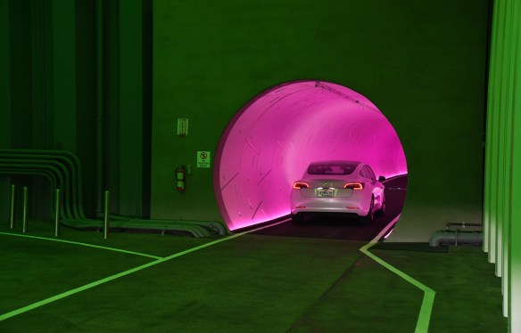 A Tesla car drives through a tunnel in the Central Station during a media preview of the Las Vegas Convention Center Loop