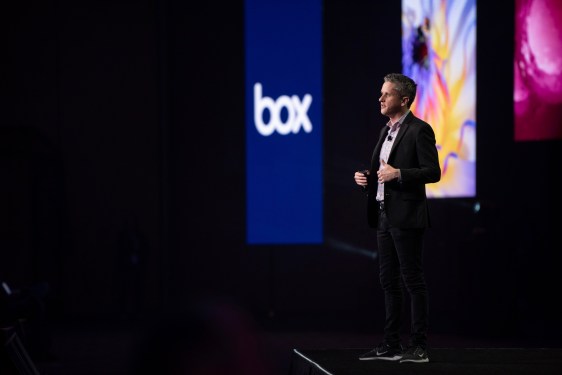 Aaron Levie CEO of Box on stage in front of Box logo.