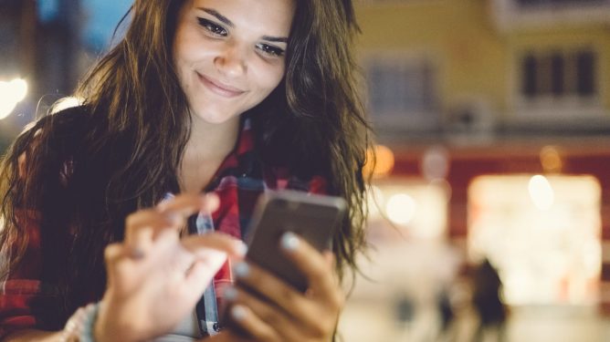 Teenage girl using smartphone