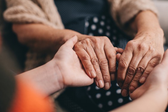 Close up of grandmother and granddaughter holding hands