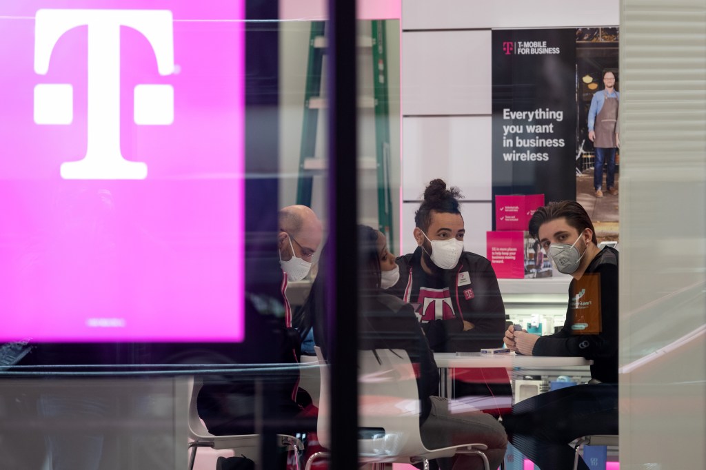 A group of employees in a T-Mobile store in New York.