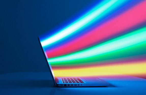 Laptop computer streaming data.(Digital composite.)