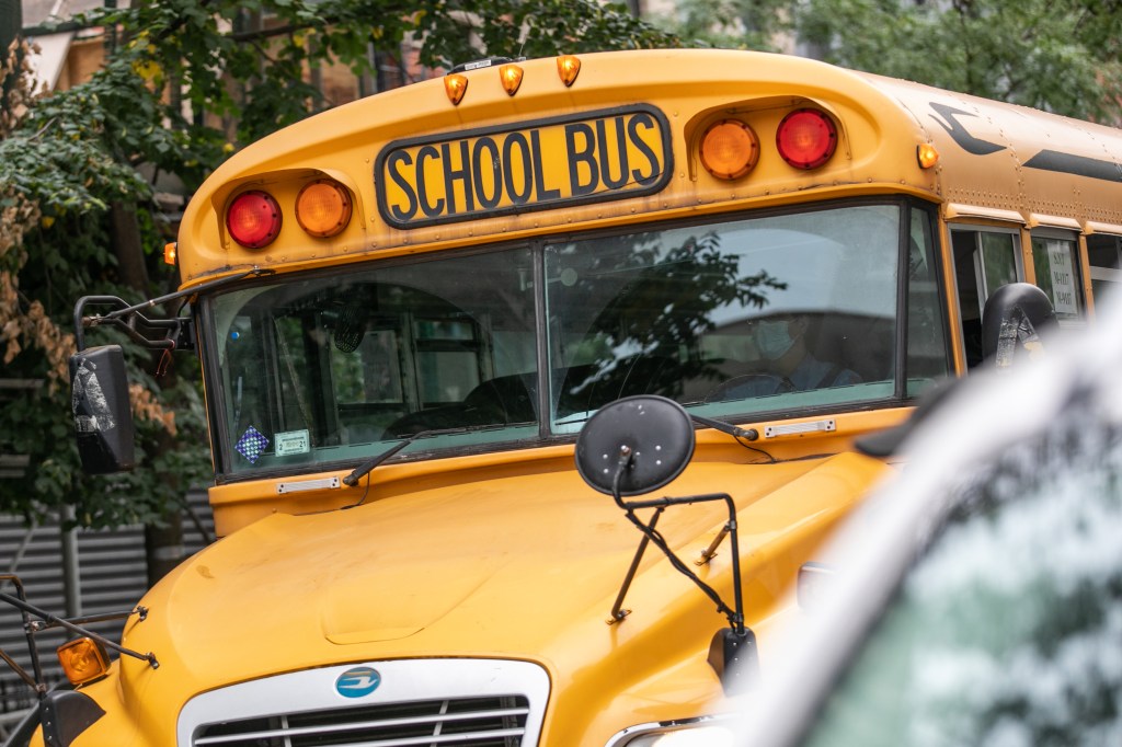 A school bus moves along a street in New York