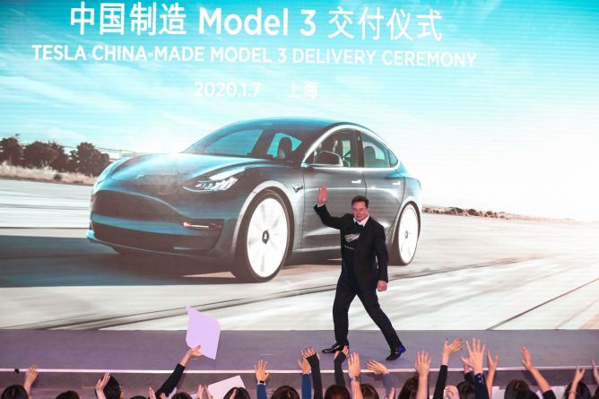 Tesla CEO Elon Musk gestures during the Tesla China-made Model 3 Delivery Ceremony in Shanghai.
