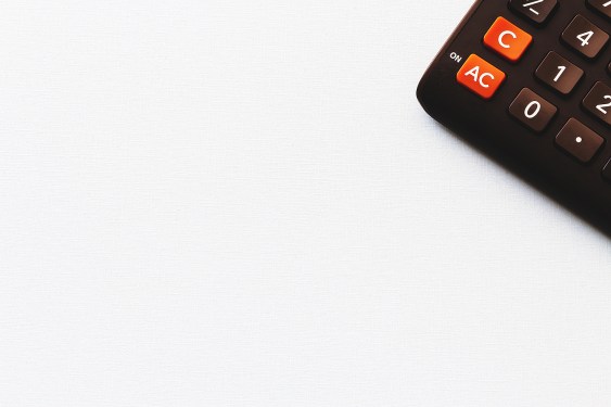 Calculator on white textured background , copy space