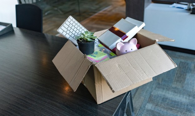 Moving office and packing belongings in a box, layoffs