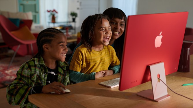 kids in front of red iMac