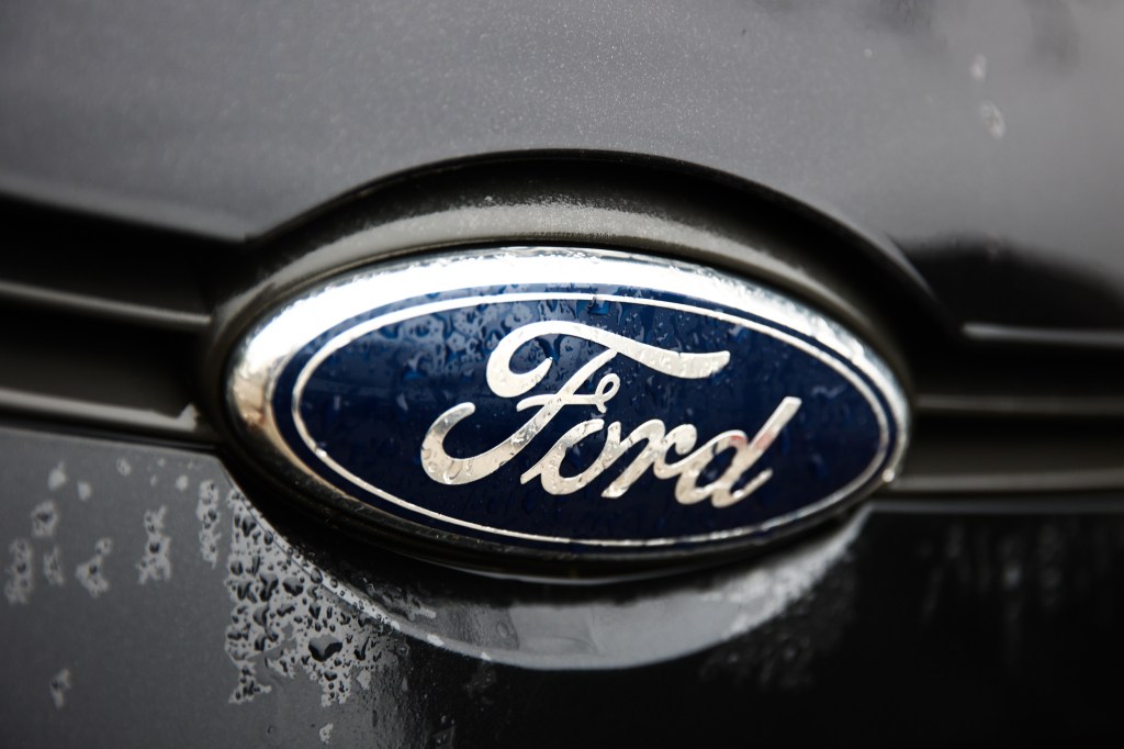 A Ford logo is seen on a gray car.