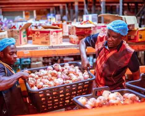 Online grocery startup Pricepally workers hoist basket of onions