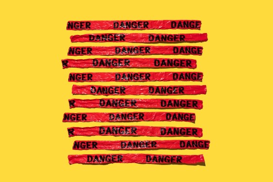 Crumpled Danger Cordon Stripes on Yellow Colored Background.