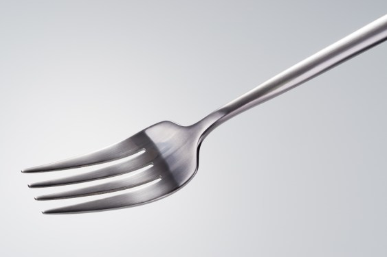 Side Shot of a Silver Colored Fork Against White Background.