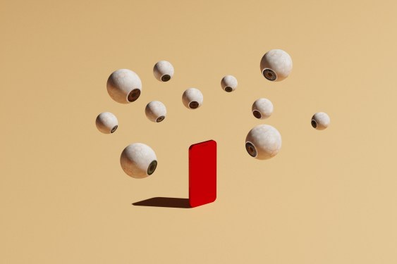 Conceptual image with a bunch of floating eyeballs in different sizes overlooking a red phone, could symbolize ideas around how we are being tracked and watched online on social media
