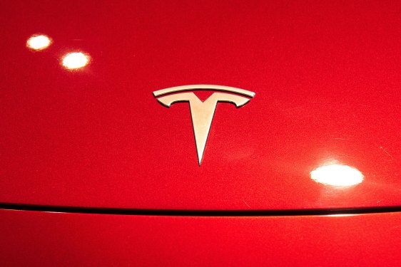 A Tesla logo seen on a Tesla Model 3 car.