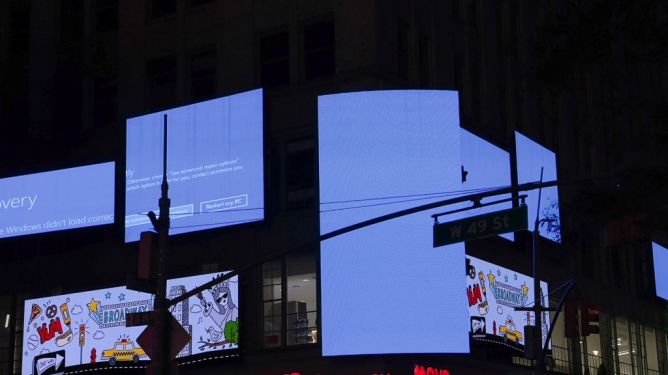 Times Square billboards displaying Windows blue screen of death after CrowdStrike outage on July 19, 2024.