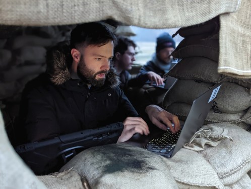 Man at laptop in a defense bunker