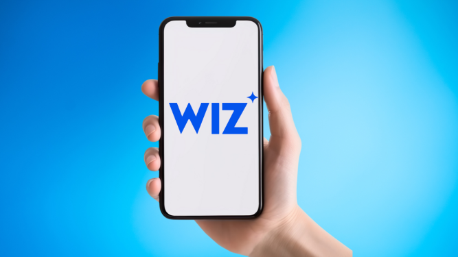 Wiz logo on smartphone held in extended hand