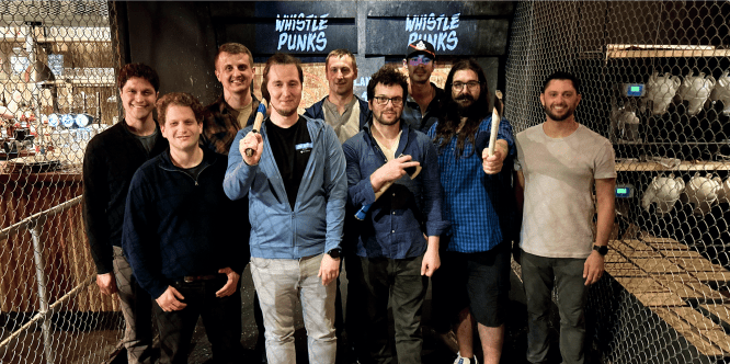 Image of the Plural team at an axe-throwing establishment.