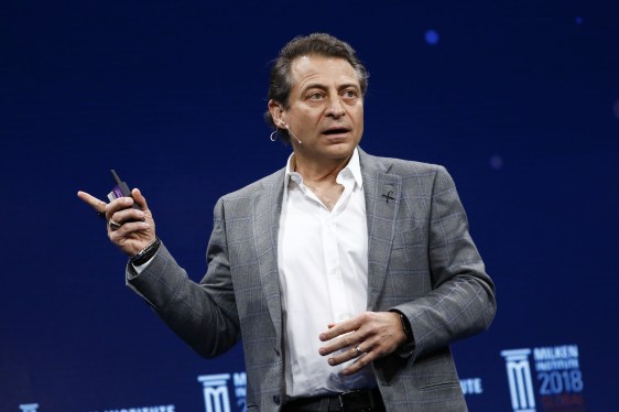 Peter Diamandis onstage pointing off camera