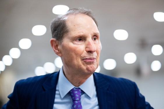 a photo of Ron Wyden in the Senate speaking to a reporter on April 8, 2025