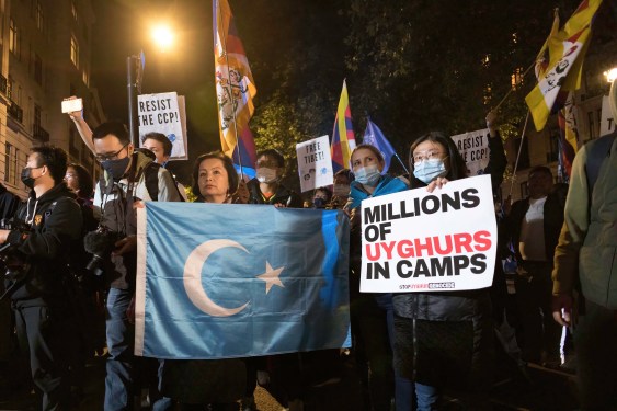 Rahima Mahmut (L), UK director of World Uyghur Congress holds an East Turkestan Flag during the demonstration. On October 1st, various anti-China Diasporas in London came together in solidarity against the Chinese Communist Party.