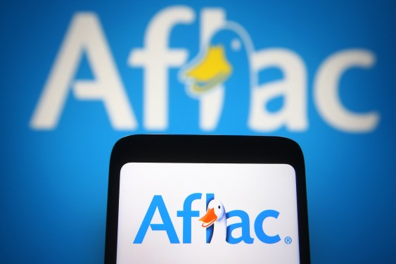 In this photo illustration the Aflac logo of an US insurance company is seen on a smartphone and a pc screen.