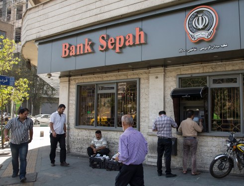 Customers use an automated teller machine (ATM) outside a Bank Sepah bank branch in Tehran, Iran, on Wednesday, Aug. 26, 2015.