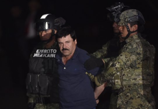 Drug kingpin Joaquin "El Chapo" Guzman is escorted by marines to a helicopter at Mexico City's airport on January 8, 2016 following his recapture during an intense military operation in Los Mochis, in Sinaloa State.
