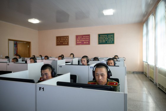 Students wearing Korean People's Army (KPA) uniforms sit before computer screens as they attend a class at the Mangyongdae Revolutionary School outside Pyongyang.