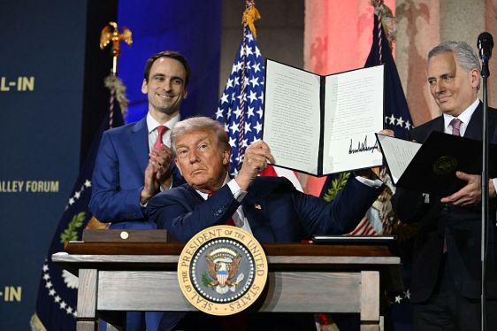 US President Donald Trump displays an executive order on artificial intelligence he signed at the "Winning the AI Race" AI Summit at the Andrew W.