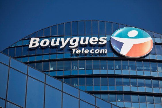 a logo outside the headquarters of Bouygues Telecom, against a blue sky background