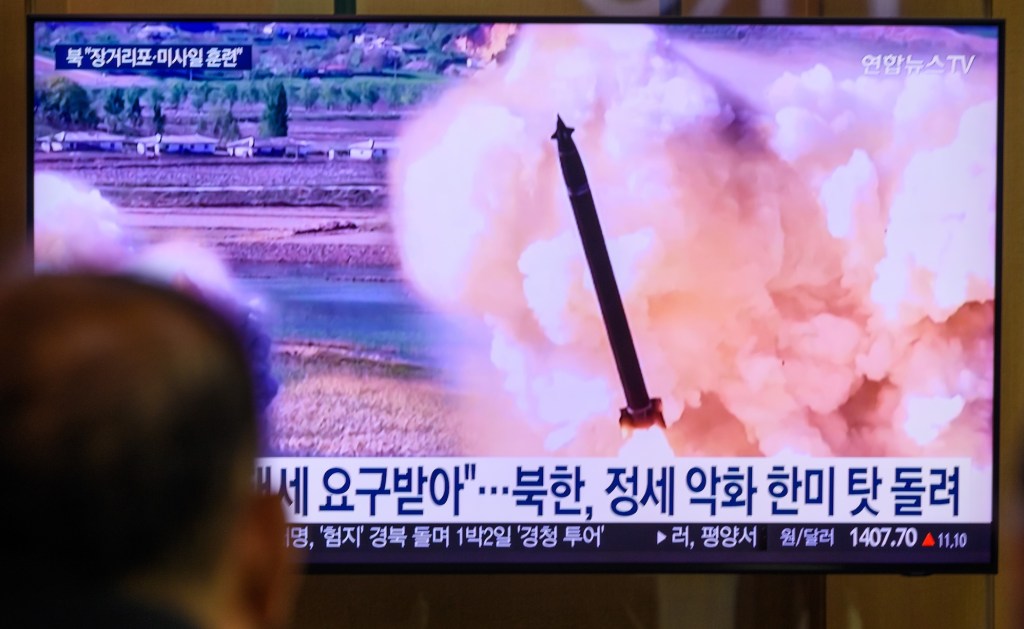 a photo of a tv screen in South Korea showing the broadcast and chryon of a North Korean missile launch.