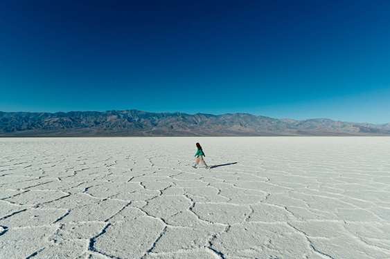 Woman walking on a salt flat.