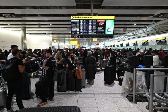 Travellers wait in terminal 4 at Heathrow Airport, west of London on September 20, 2025. Major European airports including Brussels, Berlin and London's Heathrow were Saturday hit by "cyber-related disruption" affecting check-in and baggage drop systems and causing delays, airport service provider Collins Aerospace told AFP.
