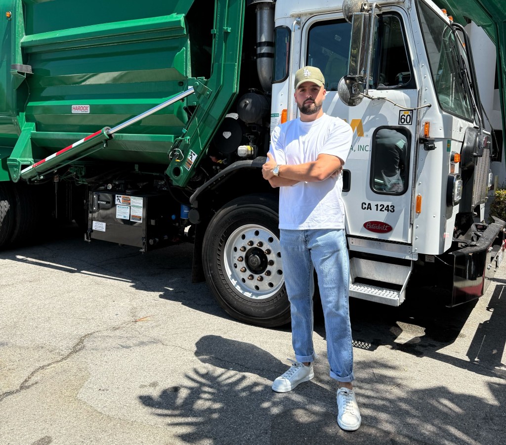 David Berg in front of a Waste Management truck.