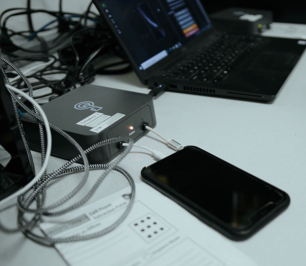 A man operates a Graykey phone hacking and unlocking device, made by Magnet Forensics. (Image: Magnet Forensics)