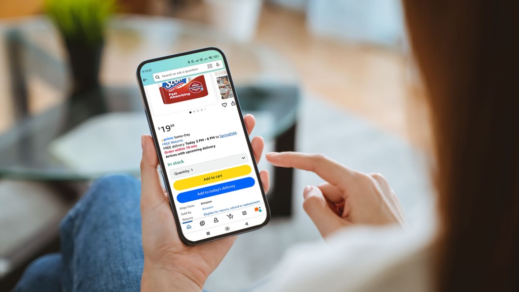 A person holding phone with Amazon app open